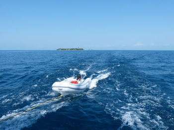 High angle view of boat tied to rope on sea against sky