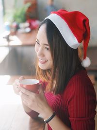 Close-up of smiling woman holding coffee cup