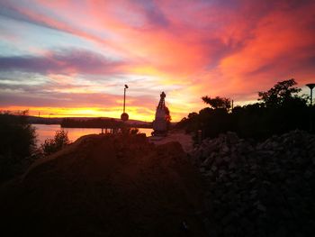 Silhouette of building against sky during sunset