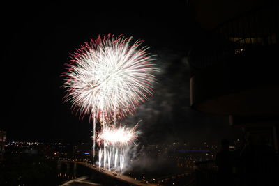 Low angle view of firework display at night