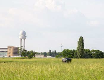 View of grassy field against cloudy sky