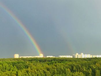 Scenic view of rainbow over landscape against sky