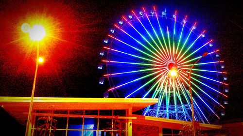 Low angle view of illuminated ferris wheel