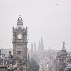 Buildings in city against clear sky