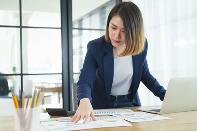 Woman using mobile phone at table