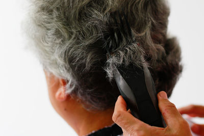 Rear view of man with hand on white background