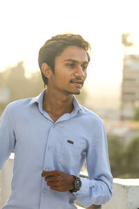 Portrait of man standing against sky