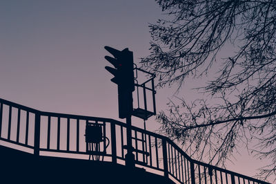 Low angle view of silhouette bridge against sky during sunset