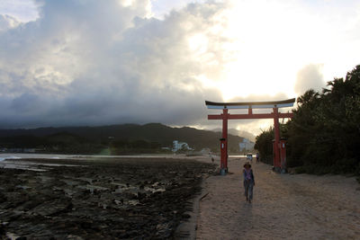 Rear view of a woman walking on beach