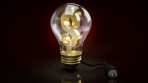 Close-up of light bulb against black background