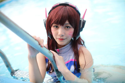 Close-up of young woman swimming in pool