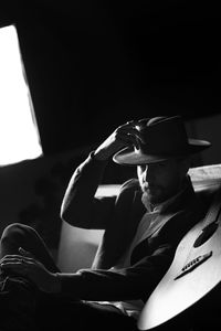 Portrait of young man sitting in hat