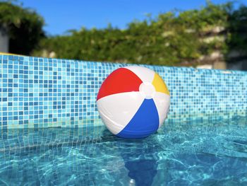 Close-up of umbrella in swimming pool