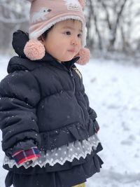 Cute girl in snow on field