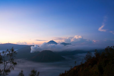 Scenic view of mountains against cloudy sky