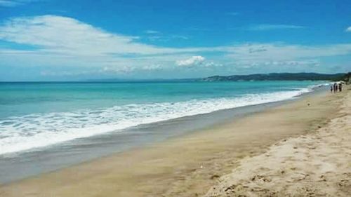 View of beach against cloudy sky