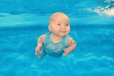 Cute baby boy swimming in pool