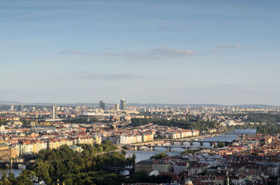 High angle view of city lit up against sky