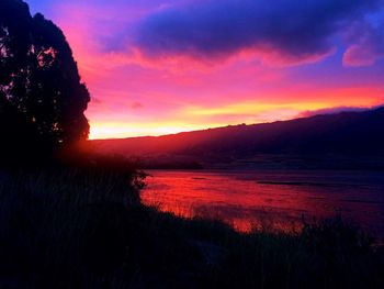 Scenic view of silhouette mountains against sky during sunset