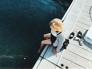 High angle view of boy sitting on boat