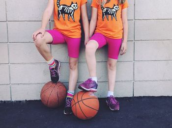 Low section of girls with basketball