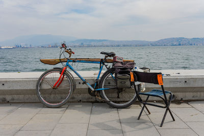 Bicycles on beach against sky