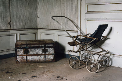 Abandoned bicycle against wall