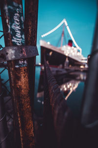 Close-up of bicycle on bridge against sky at night