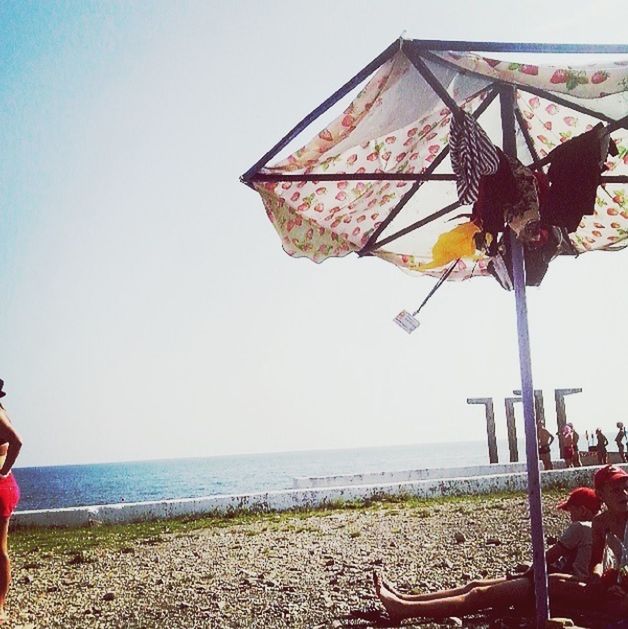 sea, beach, horizon over water, water, clear sky, shore, parasol, flag, beach umbrella, sky, sand, umbrella, scenics, vacations, tranquility, leisure activity, sunshade, tranquil scene, nature