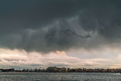 Panoramic view of sea against storm clouds