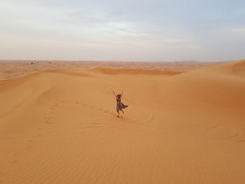 Woman jumping at desert