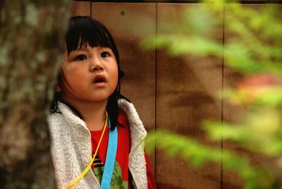 Portrait of cute girl looking away outdoors