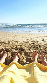 Scenic view of beach against blue sky