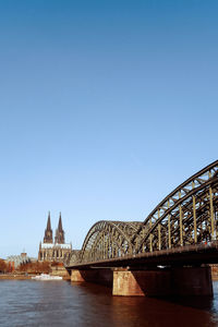 Bridge over river against blue sky