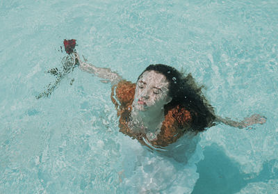 High angle view of woman swimming in sea