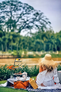 Rear view of woman sitting on garden,fall