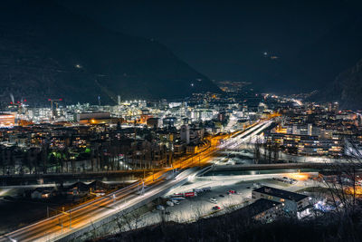 High angle view of illuminated cityscape against sky at night