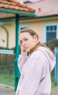 Side view of young woman standing outdoors