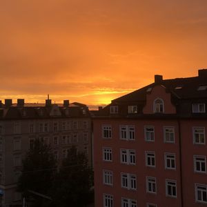 Low angle view of buildings against sky during sunset