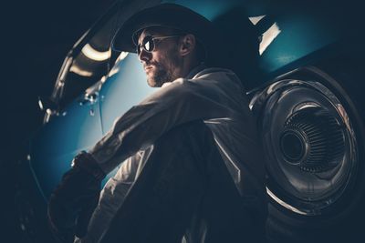 Man leaning against parked car