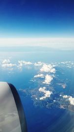 Aerial view of airplane flying over sea