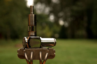 Close-up of coin-operated binoculars on field