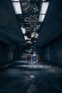 Rear view of man standing in abandoned building