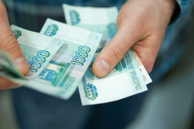 Close-up of hand holding paper currency