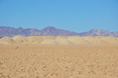 Scenic view of mountains against clear blue sky