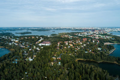 High angle view of townscape by sea against sky