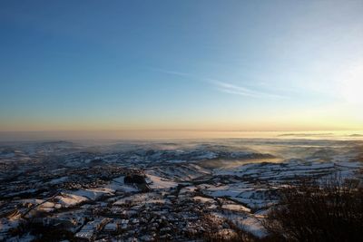 Scenic view of land against sky during sunset