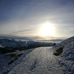 Scenic view of snowcapped mountains against sky during sunset