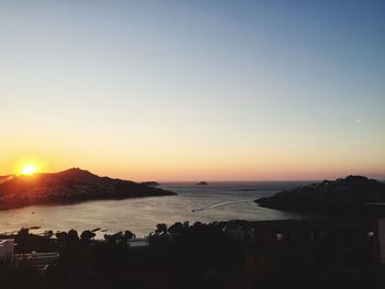 Scenic view of sea against clear sky during sunset