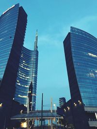 Low angle view of modern buildings against blue sky